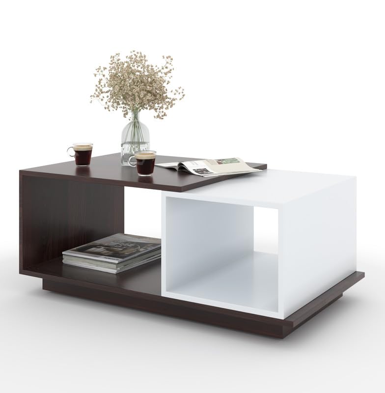 Modern coffee table with a dark top and white shelf, featuring a vase of flowers, cups, and books.